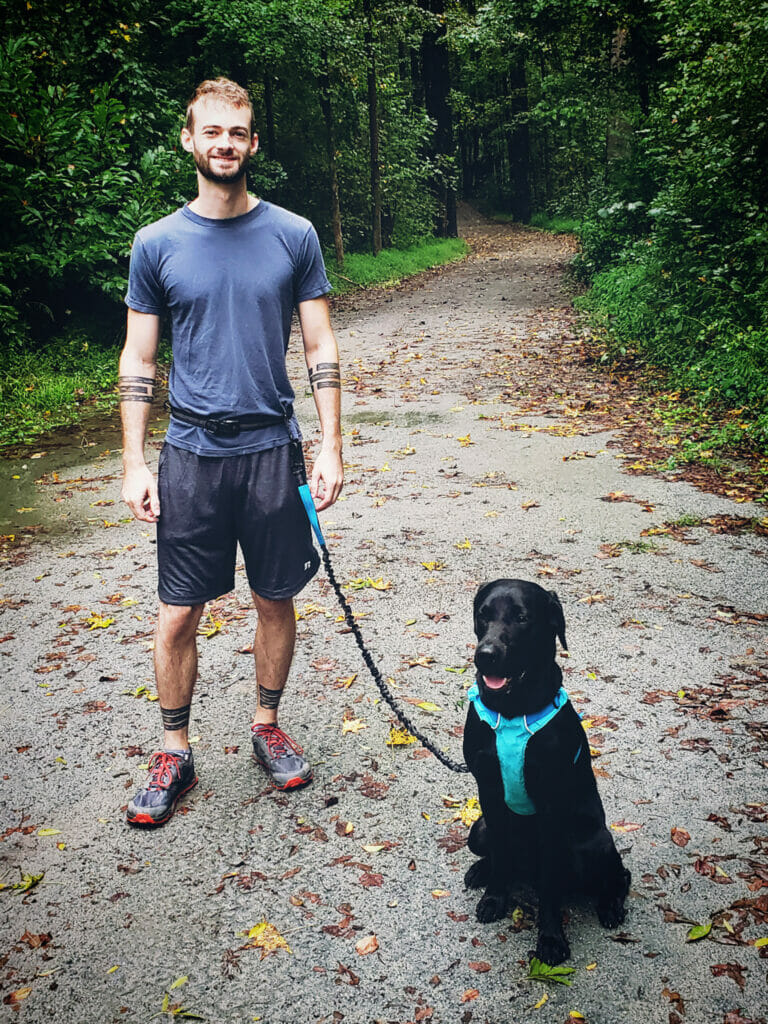 A man with his lab ready to run
