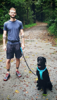 A man with his lab ready to run